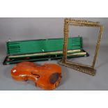 A large green velvet box, a cased pool cue, a fabric violin case,