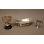 Silver, comprising; a boat shaped dish, Chester 1926 and a twin handled trophy cup, Birmingham 1937,