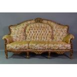 A 20th century hardwood framed three seater sofa with roll-over arms,