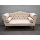 A Regency style small hump back sofa with roll over arms on turned supports, 140cm wide x 77cm high.