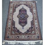 A part silk Kashan rug, Persian, the plain grey field with a floral medallion, matching spandrels,
