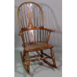 A 20th century ash and elm spindle back rocking open armchair.