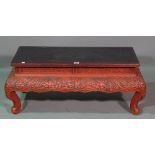 An early 20th century red cinnabar lacquer Chinese low stand,