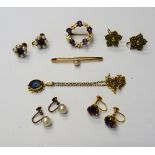 A gold and amethyst brooch, designed as a wreath, claw set with five circular cut amethysts,