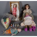 A group of eight early 20th century dolls and a quantity of doll's clothing, (8).