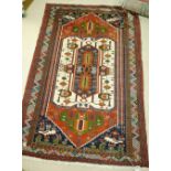 A late 20th century decorative rug with white red and blue stepped medallion within blue spandrels,