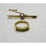 A gold and aquamarine single stone bar brooch, collet set with an oval cut aquamarine,