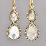 A pair of gold and silver set, diamond two stone pendant earrings,