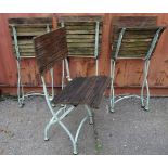 A set of four 20th century white painted folding cafe chairs, (4).