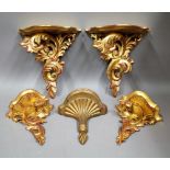 A pair of Rococo revival gilt wood wall brackets, 31cm wide x 33cm high, a matching smaller pair,