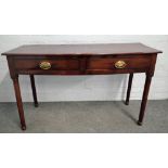 An early Victorian mahogany bowfront two drawer serving table, on turned supports,