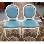 A set of six white painted Louis XVI style oval back dining chairs, on fluted supports,