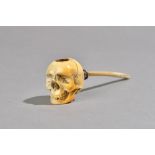 A Meerschaum pipe 19th century, the bowl carved as a human skull with animal horn mouthpiece,