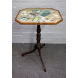 An early 19th century occasional table with trompe l'oeil top on a faux rosewood tripod base,