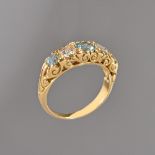 An 18ct gold, aquamarine and diamond five stone ring, mounted with three circular cut aquamarines,