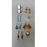 A pair of silver mounted amonite earrings, a pair of silver and gold mounted moonstone,