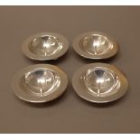A set of four candle dishes, each of circular form,