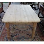 A Victorian pine plank top kitchen table on turned supports, 101cm wide x 173cm long.