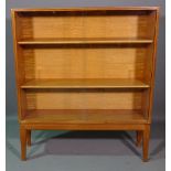 Gordon Russell; a 20th century teak display cabinet, with sliding glass doors, on tapering supports,