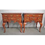 A pair of crossbanded figured walnut four drawer lowboys in the mid-18th century style, on pad feet,