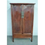 A late 19th century Chinese stained elm two door cupboard, 100cm wide x 182cm high.