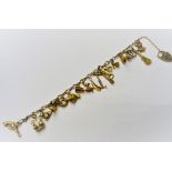 A gold charm bracelet, fitted with sixteen mostly 9ct gold charms, including a fish, a carriage,