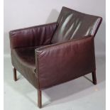 A 20th century hardwood framed armchair with faux black leather upholstery.