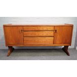 A mid-20th century teak sideboard with three central drawers,