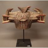 A Senufo tribal wooden two headed mask on stand,