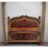 An Art Nouveau green stained and foliate carved double bed, 146cm wide x 140cm high.