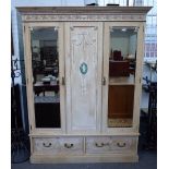 A late 19th century pine triple wardrobe with ribbon tied floral swag decoration,