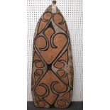 An Asmat wooden shield, West Papua, with relief carved geometric decoration,