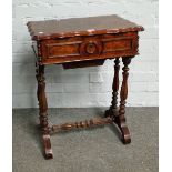 A 19th century French walnut work table with shaped lift top on baluster supports,