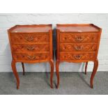 A pair of Louis XV style floral marquetry inlaid kingwood serpentine three drawer petit commodes,