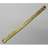 A gold bracelet, the shaped links with engine turned decoration, on a snap clasp,