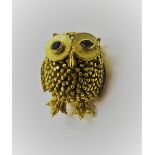 A 9ct gold brooch, designed as a winking owl, having sapphire set eyes, London 1967,