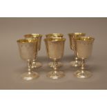 Six similar silver goblets, the bowls gilt within, the turned stems raised on circular feet,