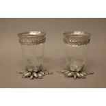 A pair of silver plated metal mounted glass vases,