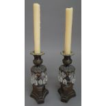 A pair of early 19th century lustre candlesticks on triform bases, 18.
