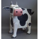 A set of three novelty cow chests, modelled standing, the tail formed as a handle, 72cm high, (3).