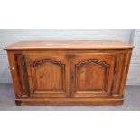 A 19th century French oak dresser base with pair of arch panel doors, 161cm wide x 85cm high.