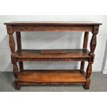 A 17th century and later carved oak three tier buffet on tapering square supports,