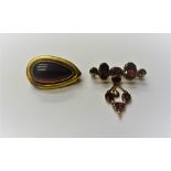 A Victorian gold and carbuncle garnet set brooch, of drop shaped form,