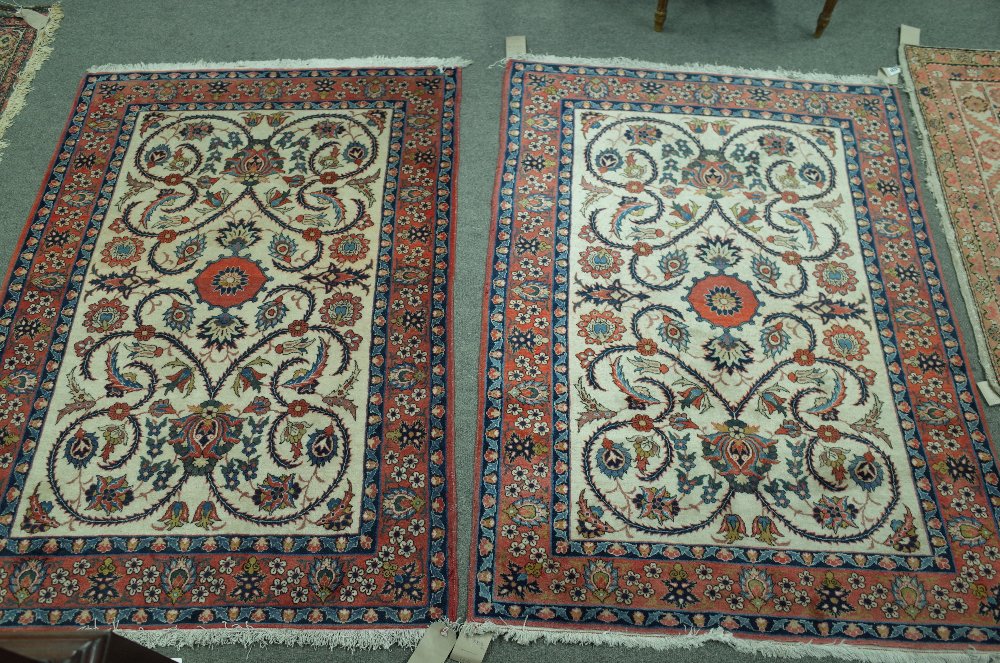 A pair of Isfahan rugs, Persian, each with an ivory field,