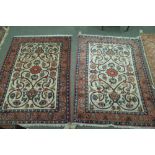 A pair of Isfahan rugs, Persian, each with an ivory field,