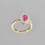 A gold, ruby and diamond oval cluster ring, collet set with the oval cut ruby at the centre,