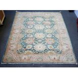 A modern Egyptian carpet, the sage field with an overall bold floral design,