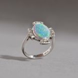 A platinum, opal doublet and diamond ring, in a cruciform design,