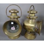 A pair of five inch Lucas 'Kind of the Road' green painted brass cased automobile oil lamps, (2).
