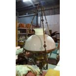 A Victorian style gilt metal hanging oil lamp (converted to electricity),